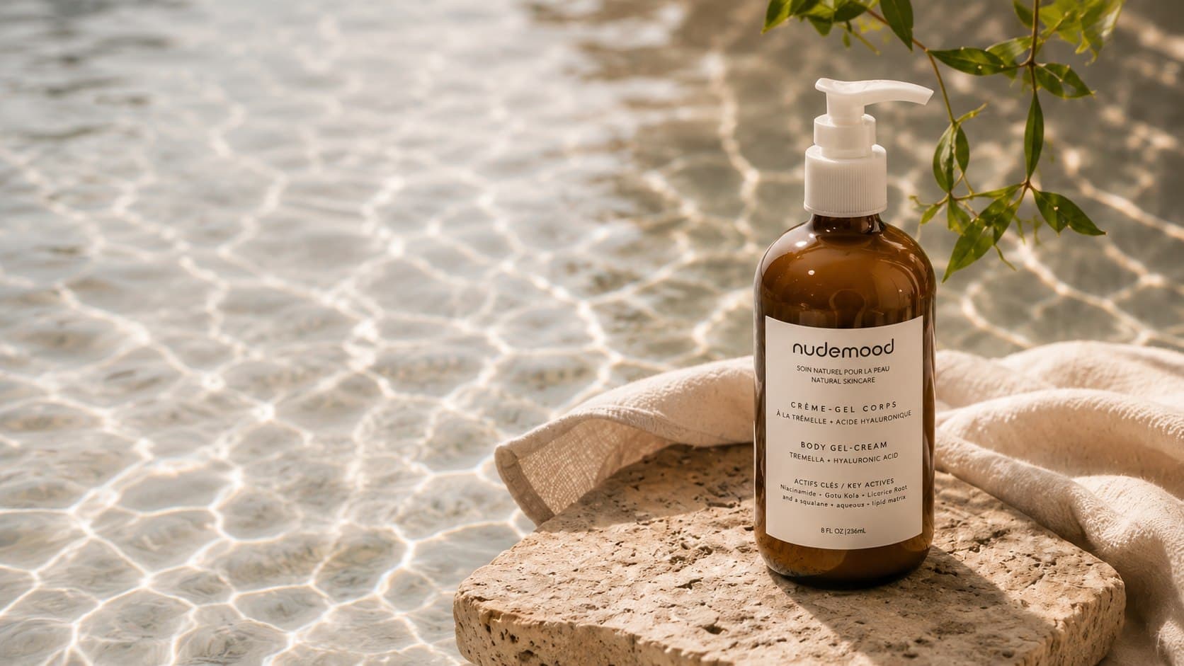 Body Gel-Cream bottle resting on a stone at the water's edge, with sunlit ripples behind it